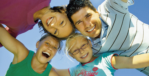 a family huddled together smiling