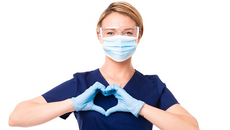 Doctor holding her hands in a heart shape